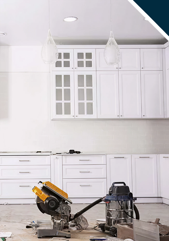 Unfinished kitchen with white cabinetry