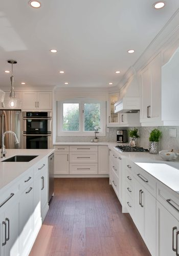 Modern white kitchen with stainless steel appliances